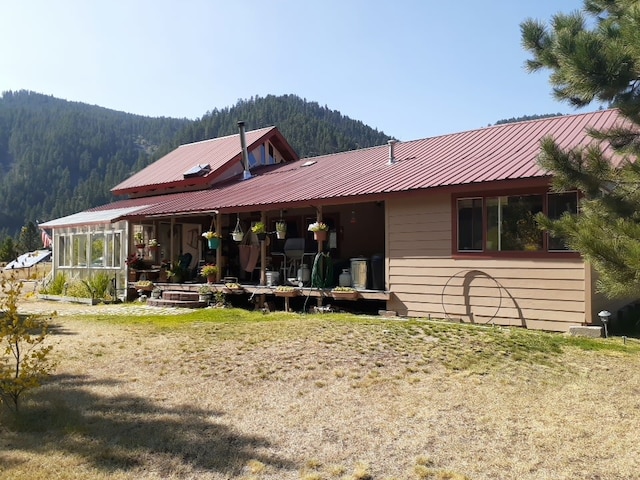 30 Idle Hour Way, Clinton, MT 59825 - back of house featuring a mountain view, a wooded view, and a metal roof