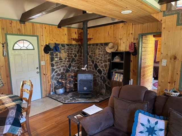30 Idle Hour Way, Clinton, MT 59825 - living area featuring wooden walls, a wood stove, beamed ceiling, and wood finished floors