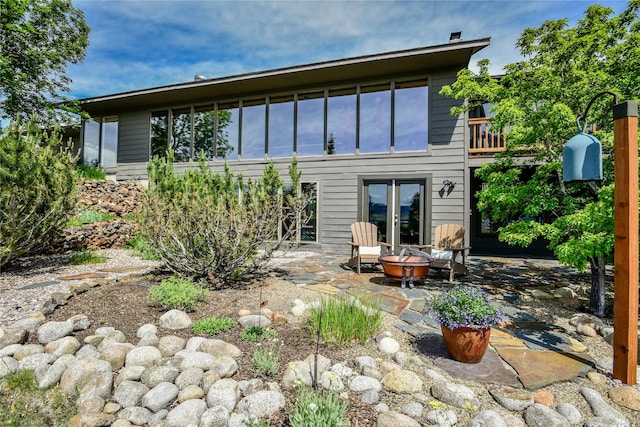 1087 Sunny Vista Rd, Helena, MT 59602 - back of property featuring an outdoor fire pit and a patio area