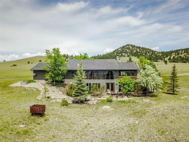 1087 Sunny Vista Rd, Helena, MT 59602 - rear view of property featuring a mountain view, a fire pit, and a yard