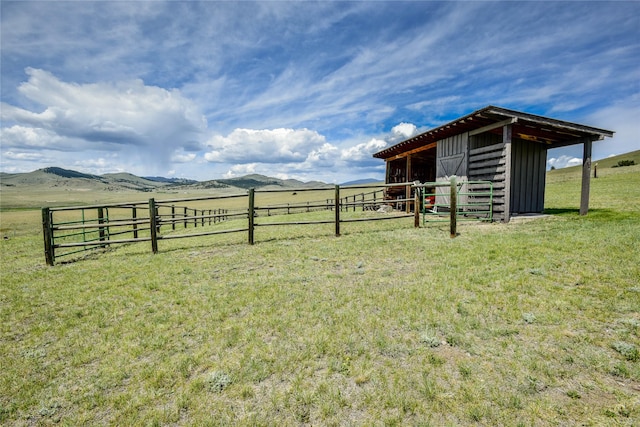 1087 Sunny Vista Rd, Helena, MT 59602 - view of yard featuring an outdoor structure, an exterior structure, a rural view, and a mountain view