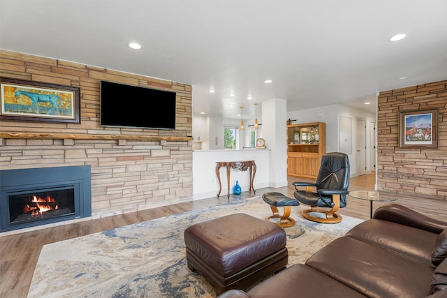 2709 Humble Rd, Missoula, MT 59804 - living room with wood finished floors, a stone fireplace, and recessed lighting
