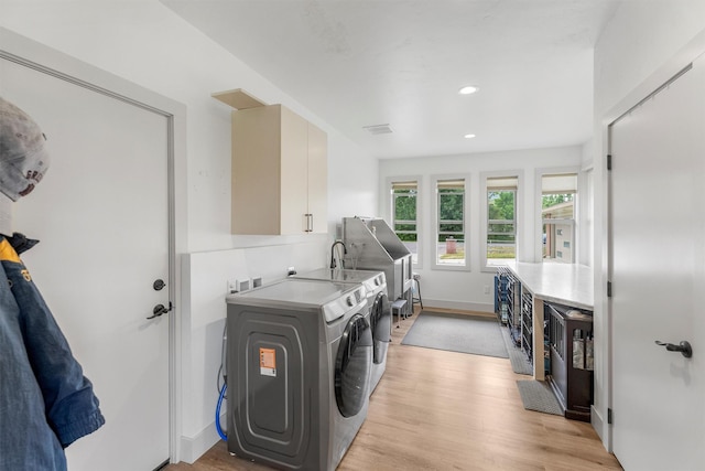 2709 Humble Rd, Missoula, MT 59804 - laundry area featuring washing machine and clothes dryer, cabinet space, light wood-type flooring, and recessed lighting
