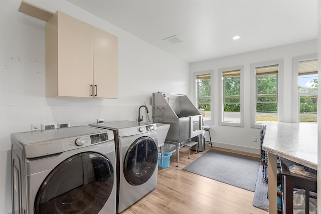 2709 Humble Rd, Missoula, MT 59804 - laundry area featuring washer and dryer, healthy amount of natural light, light wood finished floors, cabinet space, and recessed lighting