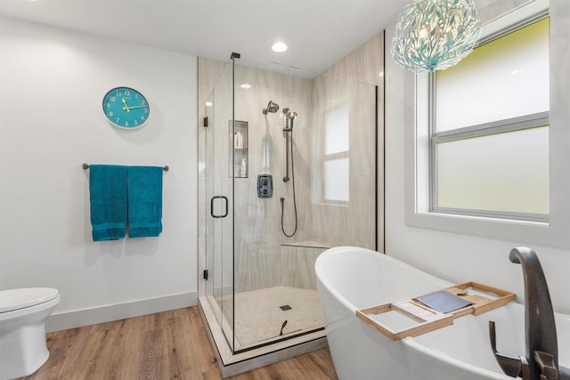 2709 Humble Rd, Missoula, MT 59804 - bathroom featuring a soaking tub, a stall shower, wood finished floors, and recessed lighting