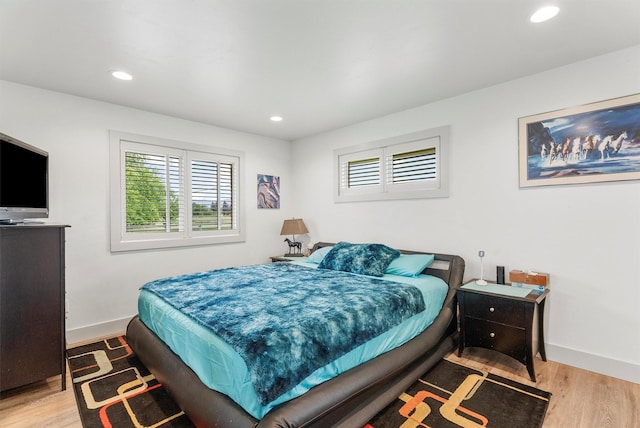 2709 Humble Rd, Missoula, MT 59804 - bedroom featuring multiple windows, wood finished floors, and recessed lighting