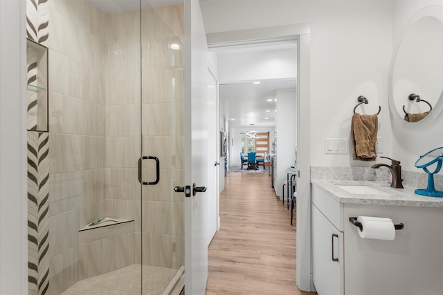 2709 Humble Rd, Missoula, MT 59804 - full bath featuring a shower stall, vanity, and wood finished floors
