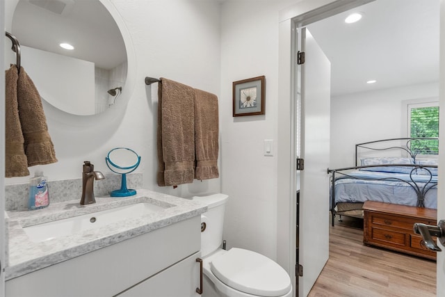 2709 Humble Rd, Missoula, MT 59804 - ensuite bathroom featuring vanity, wood finished floors, and recessed lighting