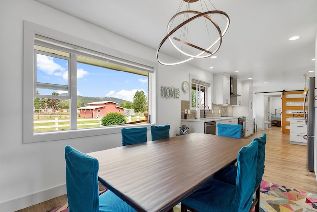 2709 Humble Rd, Missoula, MT 59804 - dining area featuring a barn door, a chandelier, light wood-style floors, and recessed lighting
