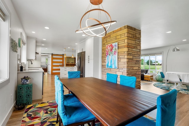2709 Humble Rd, Missoula, MT 59804 - dining space featuring a barn door, light wood-type flooring, and recessed lighting