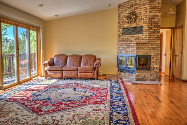 8319 Canyon Ferry Rd, Helena, MT 59602 - living area featuring a brick fireplace and wood finished floors
