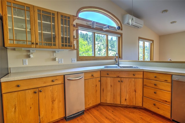 8319 Canyon Ferry Rd, Helena, MT 59602 - kitchen with a wall mounted AC, stainless steel dishwasher, vaulted ceiling, light wood-style floors, and light countertops
