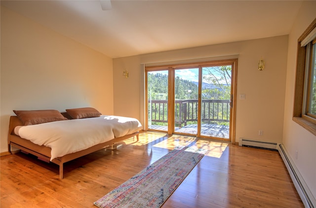 8319 Canyon Ferry Rd, Helena, MT 59602 - bedroom with a baseboard radiator, access to outside, light wood-style floors, and ceiling fan