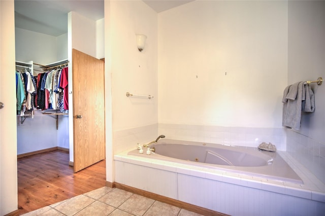 8319 Canyon Ferry Rd, Helena, MT 59602 - bathroom with a whirlpool tub, tile patterned flooring, and a walk in closet