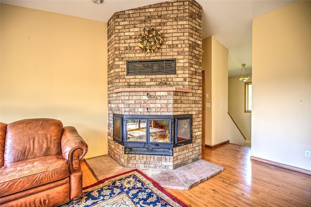 8319 Canyon Ferry Rd, Helena, MT 59602 - living area featuring a fireplace, wood finished floors, and lofted ceiling