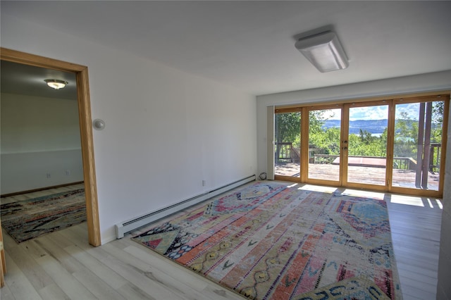 8319 Canyon Ferry Rd, Helena, MT 59602 - empty room featuring a baseboard heating unit and light wood finished floors