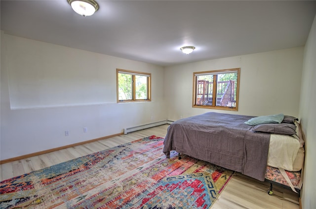8319 Canyon Ferry Rd, Helena, MT 59602 - bedroom featuring a baseboard heating unit and wood finished floors
