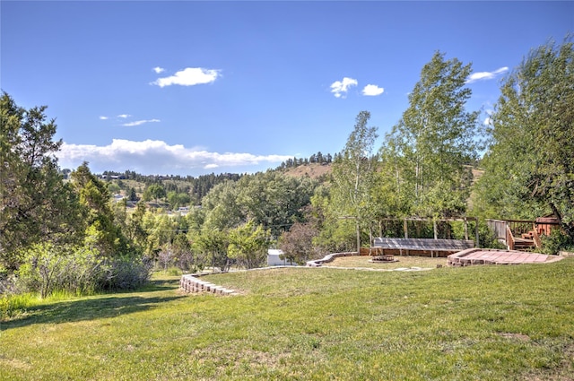 8319 Canyon Ferry Rd, Helena, MT 59602 - view of green lawn with an outdoor fire pit and a deck