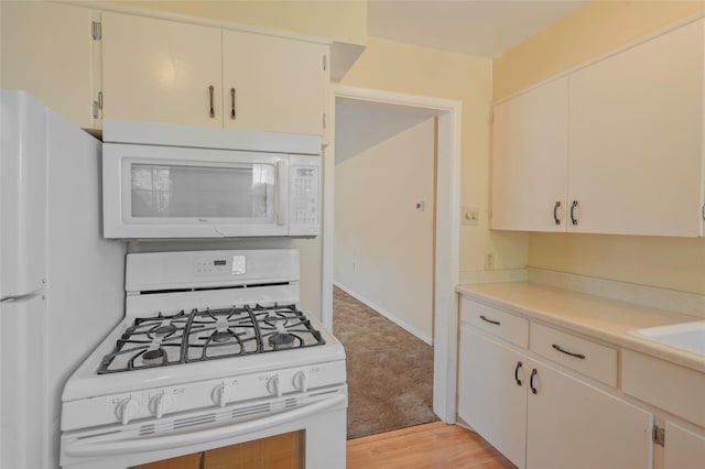 2129 E 6th Ave, Helena, MT 59601 - kitchen with white appliances, light countertops, light wood-style flooring, and light colored carpet