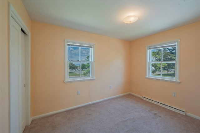 2129 E 6th Ave, Helena, MT 59601 - unfurnished bedroom featuring a baseboard radiator, carpet flooring, and a closet