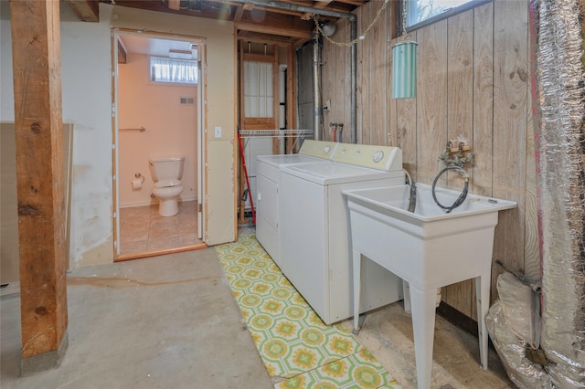 2129 E 6th Ave, Helena, MT 59601 - laundry area featuring washing machine and clothes dryer and wood walls
