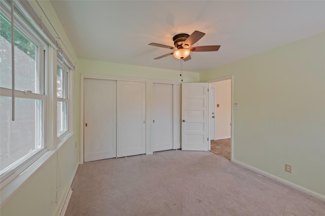 2129 E 6th Ave, Helena, MT 59601 - unfurnished bedroom with multiple closets, light carpet, and ceiling fan