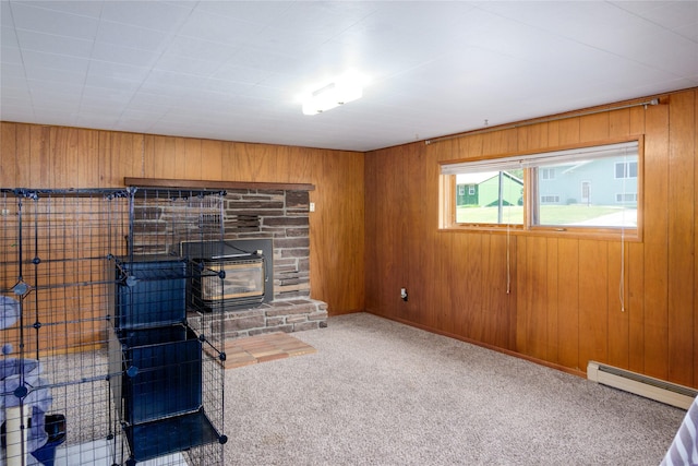 440 Dome Mountain Rd, Libby, MT 59923 - unfurnished living room with a baseboard radiator, carpet flooring, and wooden walls