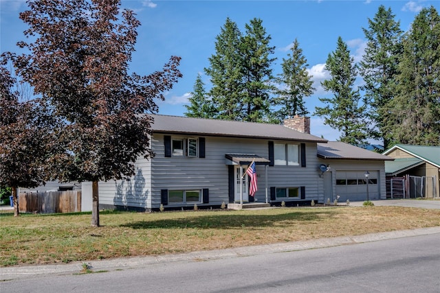 440 Dome Mountain Rd, Libby, MT 59923 - raised ranch with an attached garage, a chimney, concrete driveway, and a metal roof