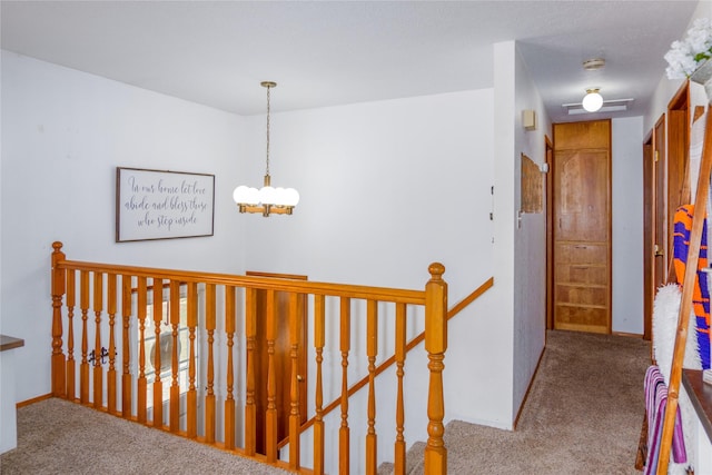 440 Dome Mountain Rd, Libby, MT 59923 - hall with an upstairs landing, carpet, and a chandelier