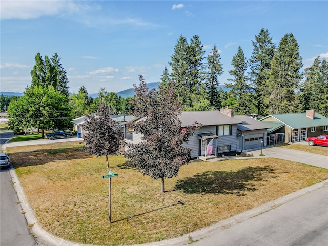 440 Dome Mountain Rd, Libby, MT 59923 - view of front of home with concrete driveway, a front lawn, a chimney, and a garage