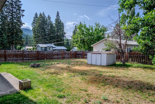 440 Dome Mountain Rd, Libby, MT 59923 - fenced backyard featuring a shed and a mountain view