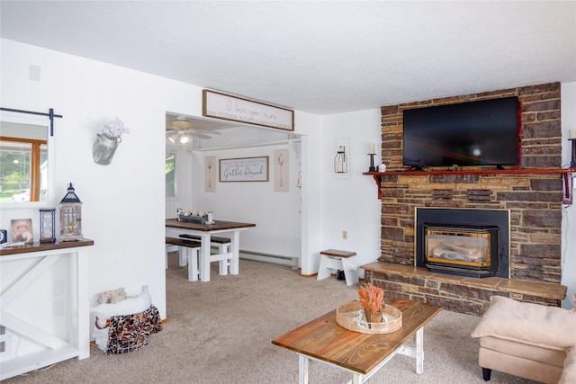 440 Dome Mountain Rd, Libby, MT 59923 - carpeted living area featuring baseboard heating, a stone fireplace, and a ceiling fan