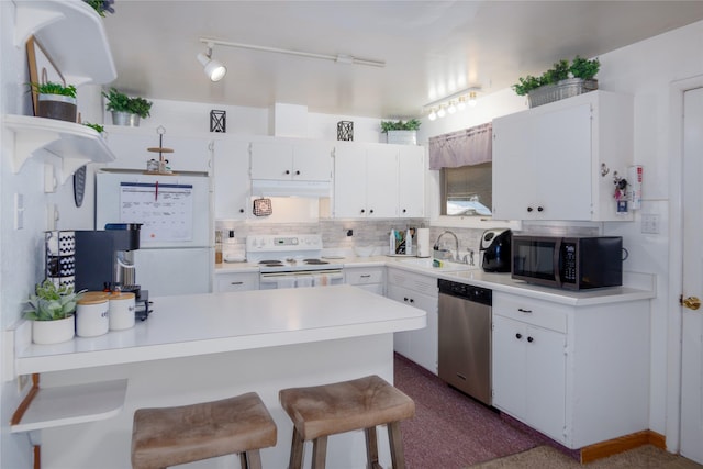440 Dome Mountain Rd, Libby, MT 59923 - kitchen with white appliances, under cabinet range hood, white cabinets, and light countertops