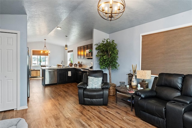 2009 22nd Ave S, Great Falls, MT 59405 - living room featuring lofted ceiling, a chandelier, and wood finished floors