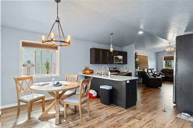2009 22nd Ave S, Great Falls, MT 59405 - kitchen featuring a chandelier, appliances with stainless steel finishes, light wood-type flooring, and light countertops