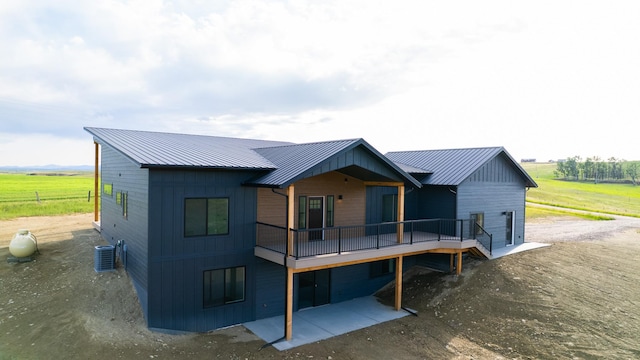 406 2nd Rd SW, Fairfield, MT 59436 - rear view of property featuring a metal roof, a standing seam roof, a view of rural / pastoral area, and a wooden deck