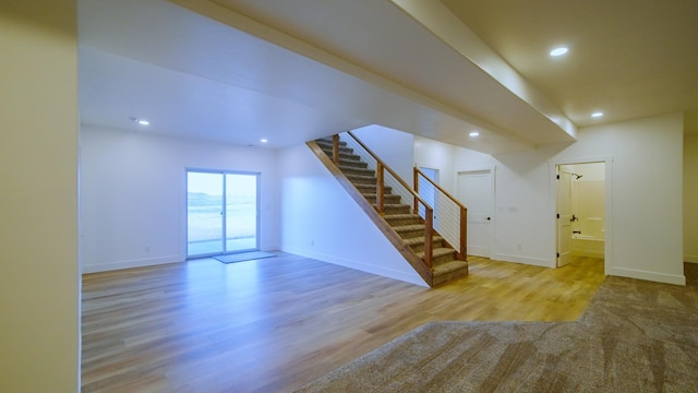 406 2nd Rd SW, Fairfield, MT 59436 - unfurnished living room with stairs, wood finished floors, and recessed lighting