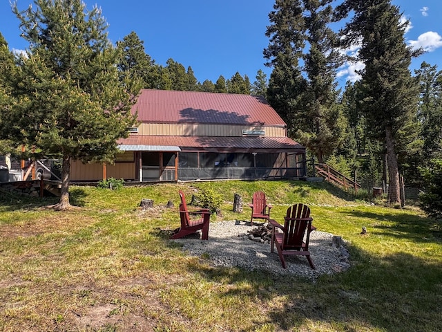 912 Muskrat Rd, Helmville, MT 59843 - back of property featuring a lawn and a metal roof