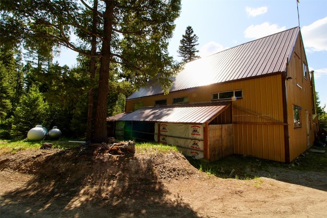 912 Muskrat Rd, Helmville, MT 59843 - back of house featuring a metal roof, a pole building, and an outdoor structure