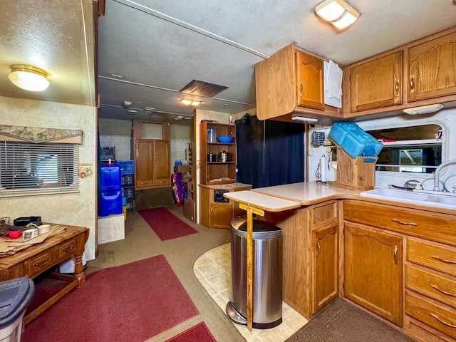 912 Muskrat Rd, Helmville, MT 59843 - kitchen with light countertops and brown cabinetry