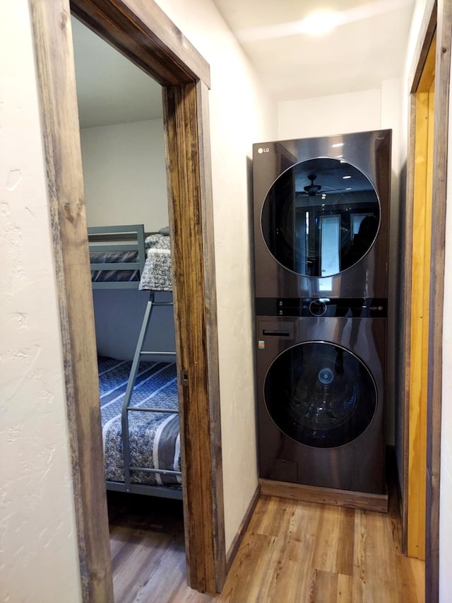 20536 Wild Horse Ranch Rd, Rollins, MT 59931 - washroom featuring estacked washer and dryer and wood finished floors