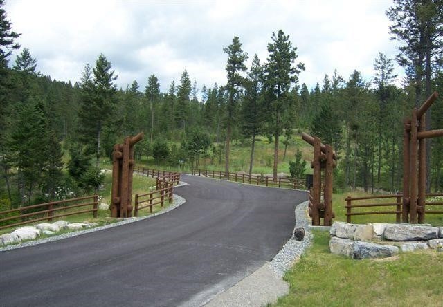 20536 Wild Horse Ranch Rd, Rollins, MT 59931 - view of asphalt road featuring a forest view