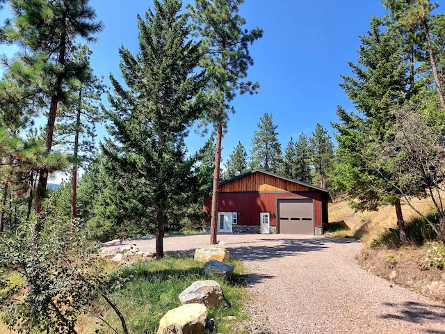 20536 Wild Horse Ranch Rd, Rollins, MT 59931 - view of home's exterior featuring a garage, an outbuilding, and driveway
