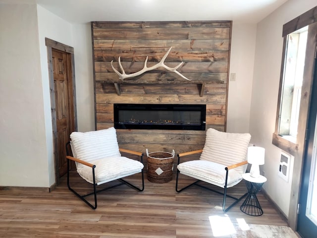 20536 Wild Horse Ranch Rd, Rollins, MT 59931 - sitting room featuring wood finished floors, a fireplace, and healthy amount of natural light