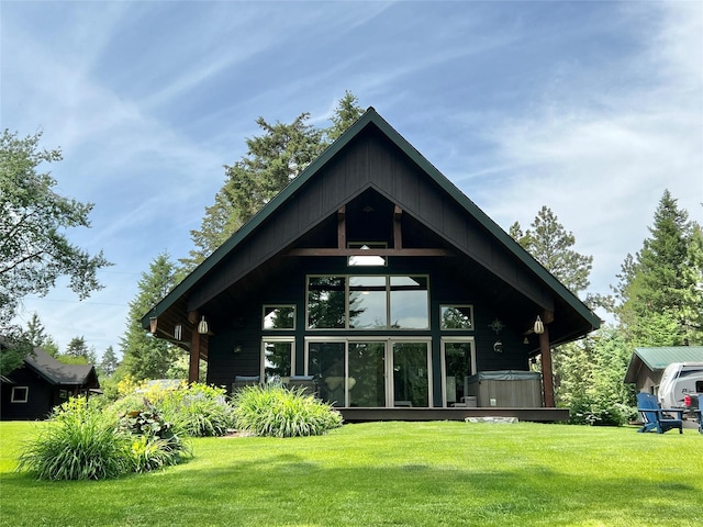 120 Chickadee Way, Whitefish, MT 59937 - rear view of property with a hot tub and a lawn
