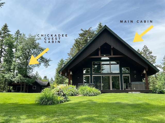 120 Chickadee Way, Whitefish, MT 59937 - back of property featuring a hot tub and a yard