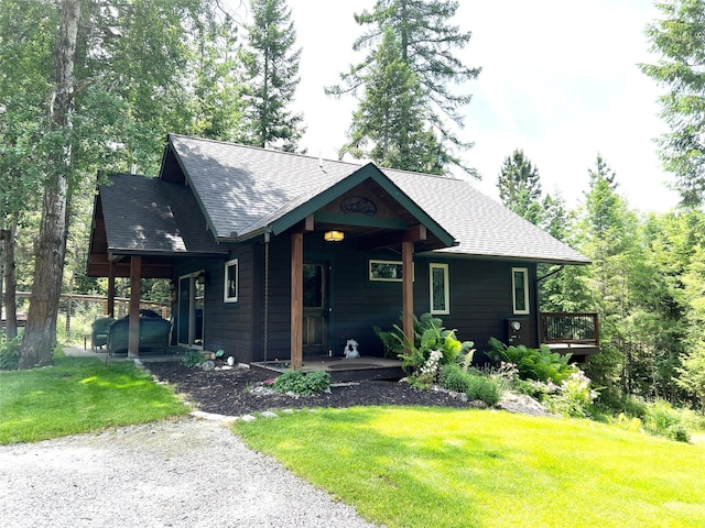 120 Chickadee Way, Whitefish, MT 59937 - view of front of home with a front yard, roof with shingles, and covered porch