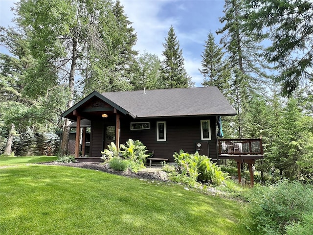 120 Chickadee Way, Whitefish, MT 59937 - rustic home featuring a front lawn, roof with shingles, and a wooden deck