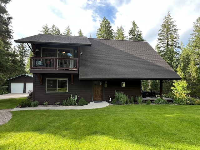 120 Chickadee Way, Whitefish, MT 59937 - view of front of house featuring a balcony, an outdoor structure, a front yard, and a detached garage