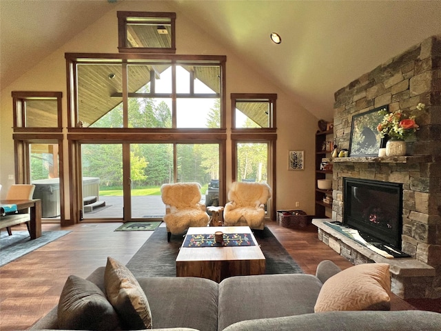 120 Chickadee Way, Whitefish, MT 59937 - living room with high vaulted ceiling, a fireplace, and wood finished floors
